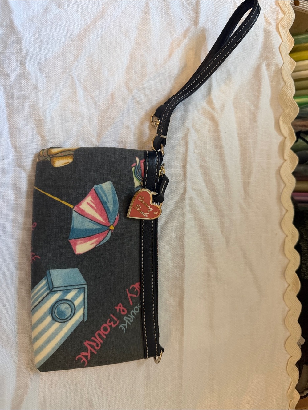 Dooney & Bourke Black Wristlet with Multicolor Umbrella & Camera Print